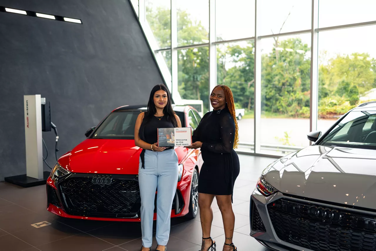 Audi Sale Specialist explaining vehicle features to a customer.