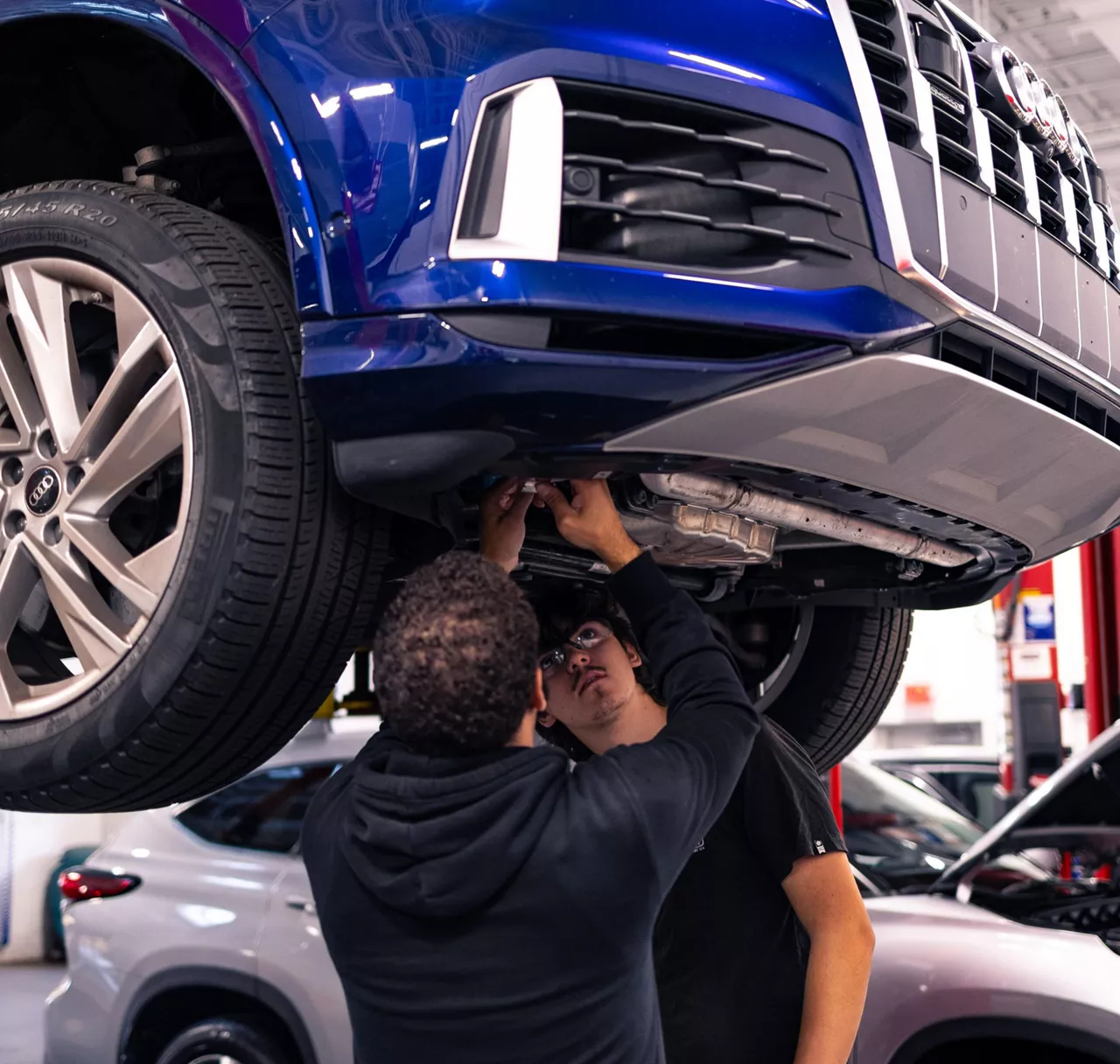 Audi employee handing a set of car keys to a customer.