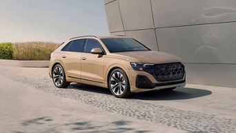 Front side view of a 2025 Audi Q8 parked.
