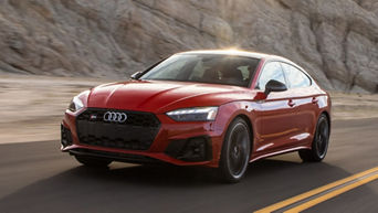 Front side view of a 2024 Audi S5 driving.