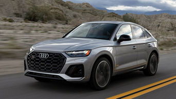 Front side view of a 2024 Audi SQ5 driving.