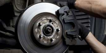 Mechanic working on a vehicle's brakes