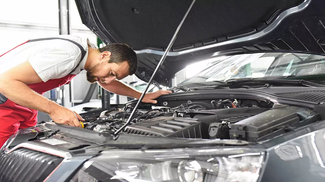 car mechanic repairs a vehicle in a workshop.