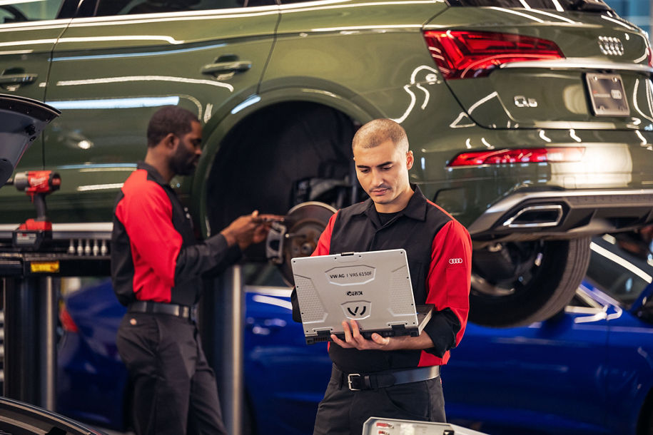 Front profile view of an Audi Service manager running diagnostics on a vehicle.