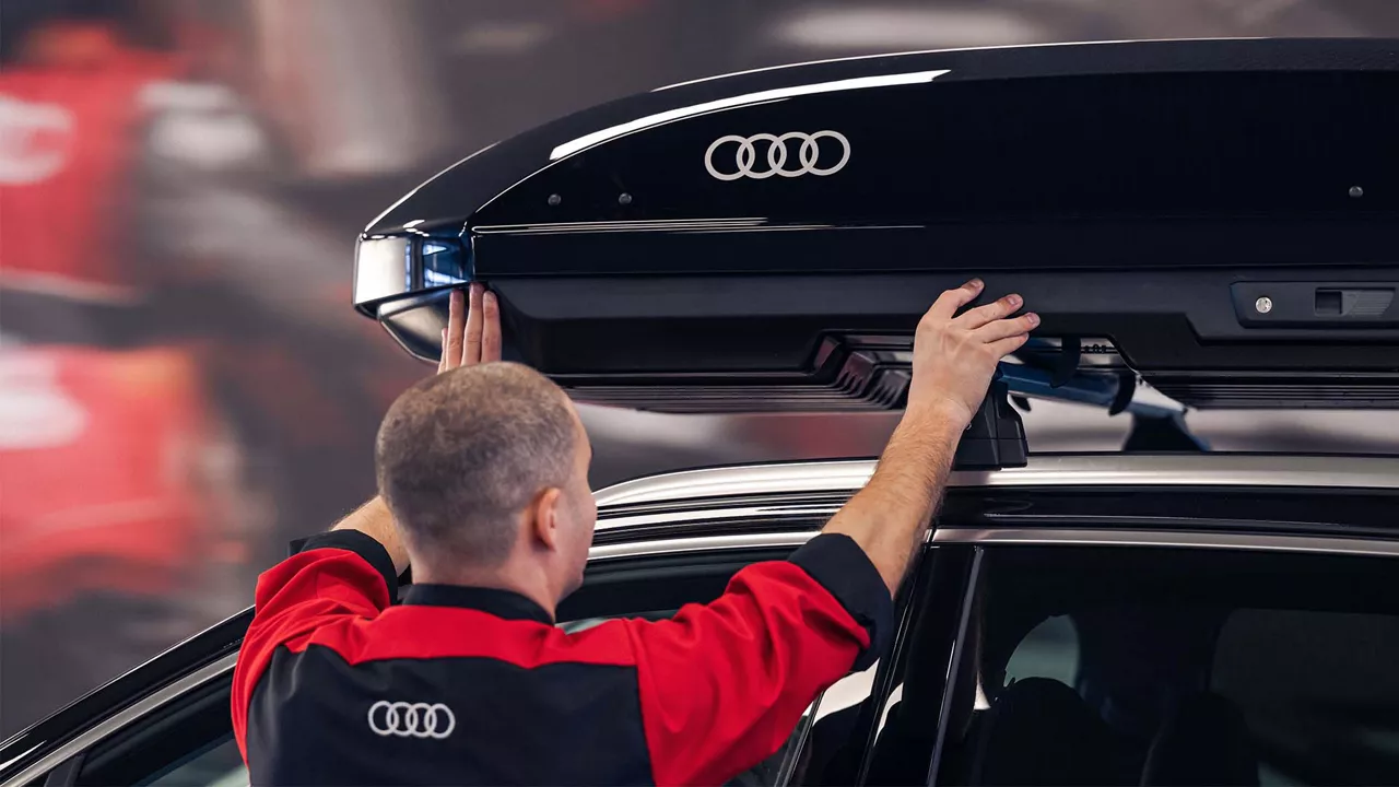 Three-quarter back view of an Audi A4 accelerating. 