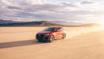 Side view of an Audi Q3 accelerating.