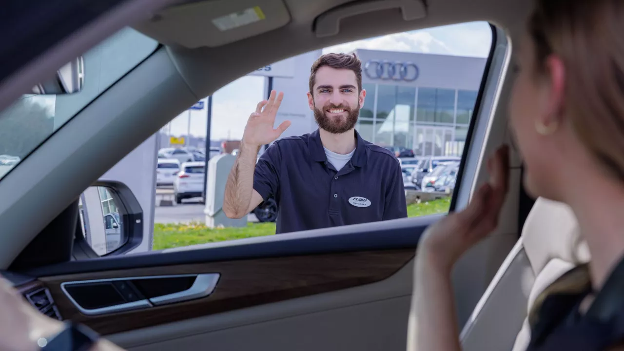 Audi employee talking to a customer.