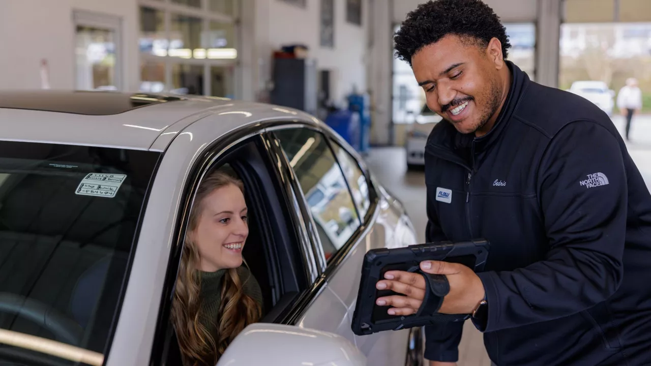 Audi service technician working with a customer.