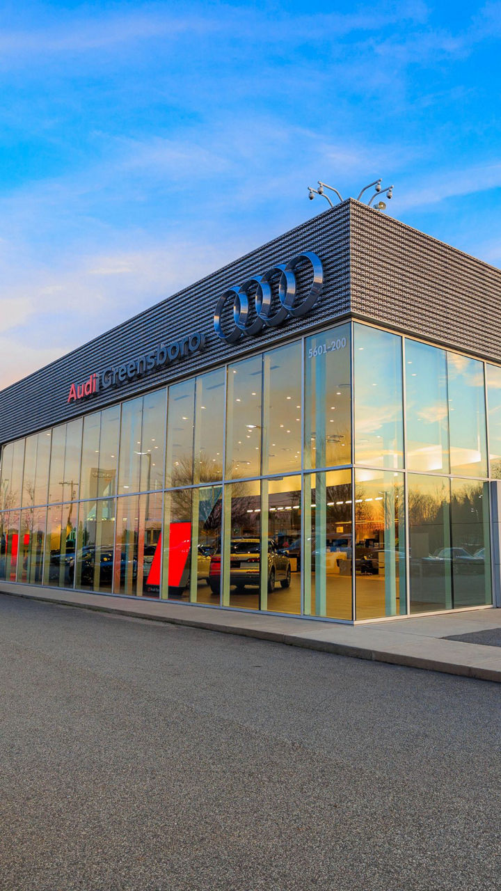 Audi Sale Specialist walking through the showroom with a couple.