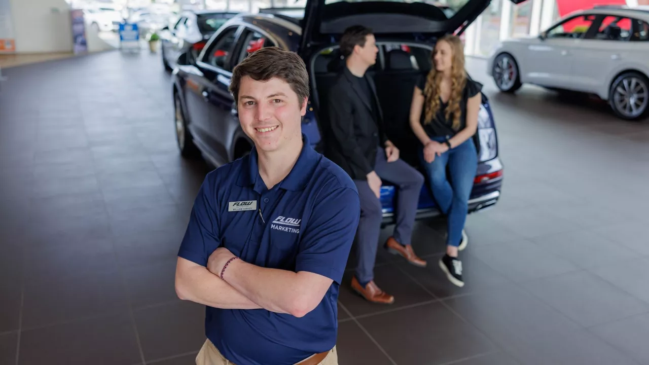 Audi Sale Specialist explaining vehicle features to a customer.