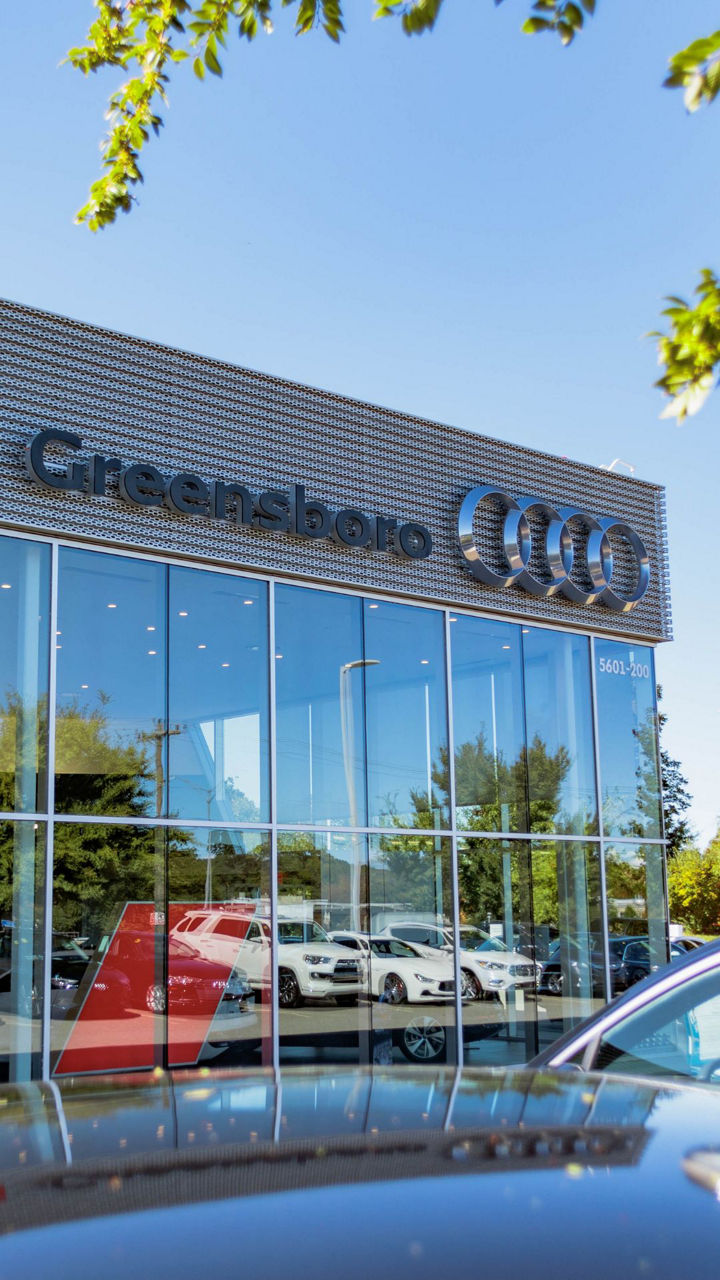 Two people chatting with each other across the charging station.