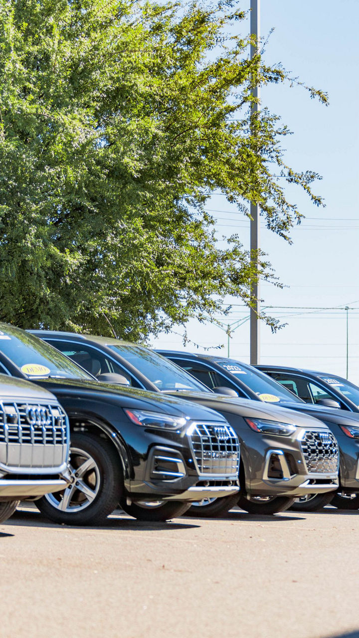 Side profile view of an Audi models parked.