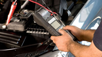 Service technician serving vehicle.