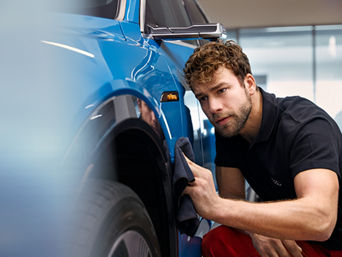 Service technician servicing vehicle.