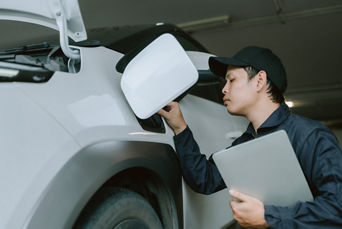Service technician servicing vehicle.
