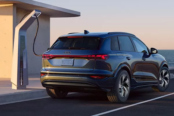Side view of an Audi SUV charging.