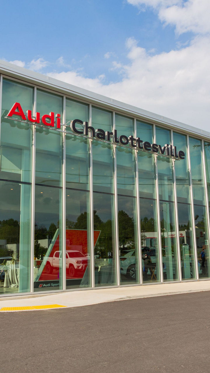 Two people chatting with each other across the charging station.