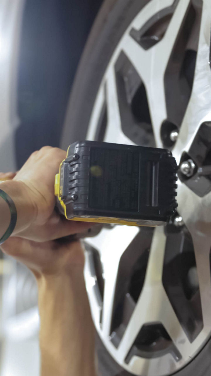 Audi service technician servicing a vehicle.