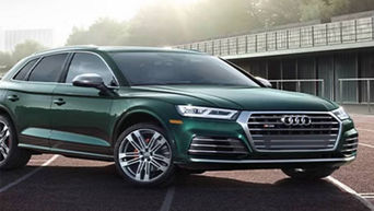 Three-quarter view of an Audi vehicle on a race track.