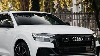 Three-quarter view of an Audi vehicle on the road.