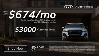 Front profile of an Audi Q7 parked.