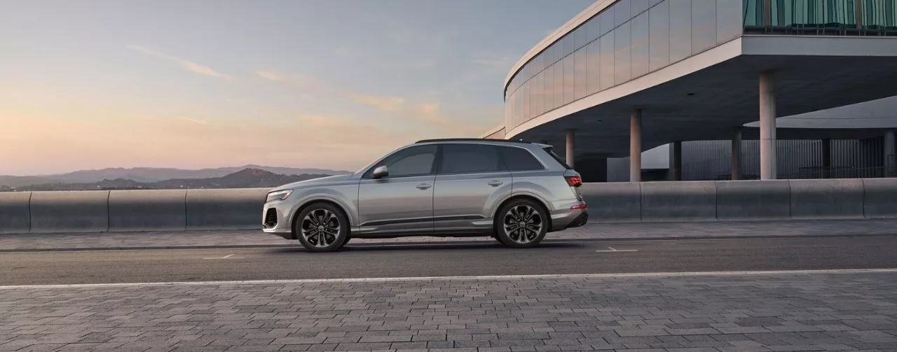 New 2025 Audi Q7 side view on a bridge