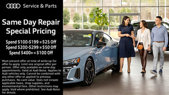 Service technician servicing vehicle with hood open.