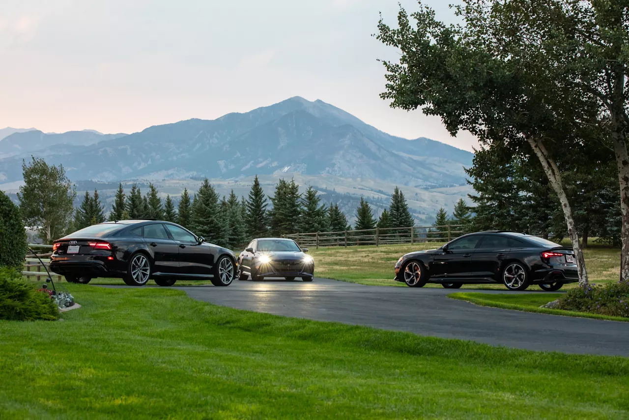View of three Audi vehicles. 