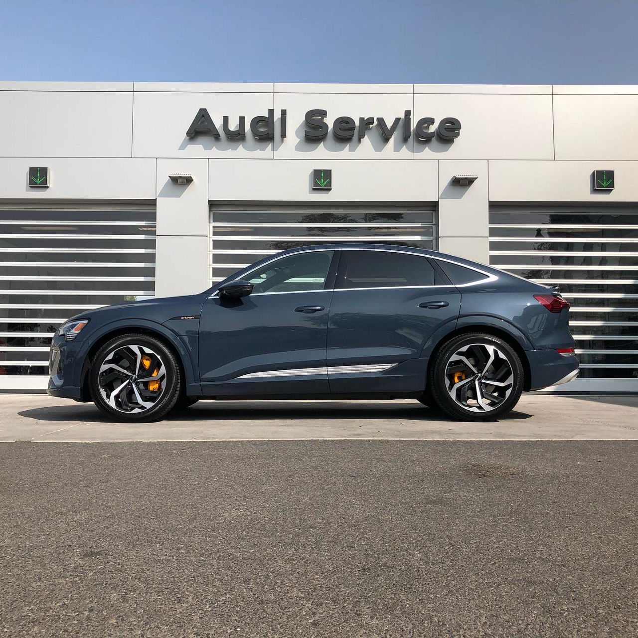 side profile of an etron in front of service doors