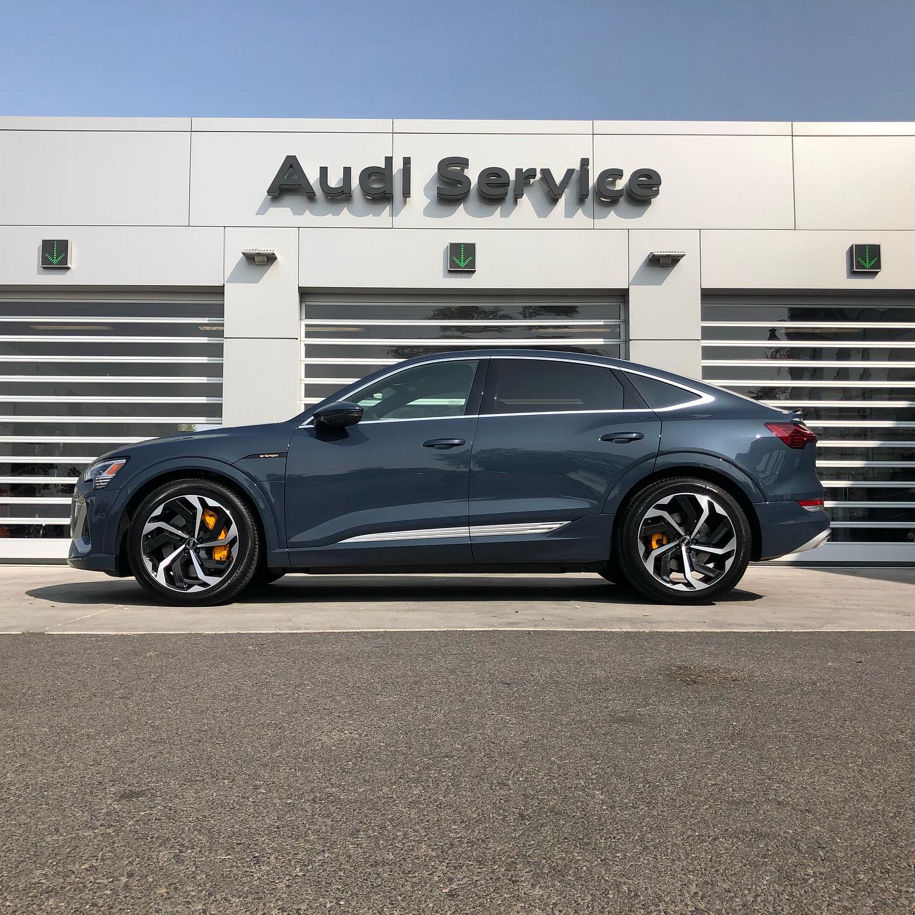 side profile of an etron in front of service doors