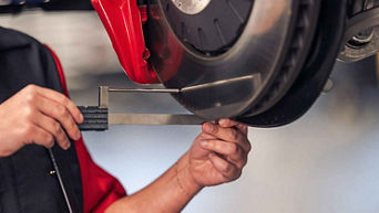 Service technician servicing vehicle.