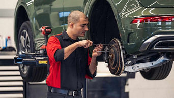 Service technician servicing tire.