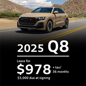 Side view of an Audi Q7 driving.