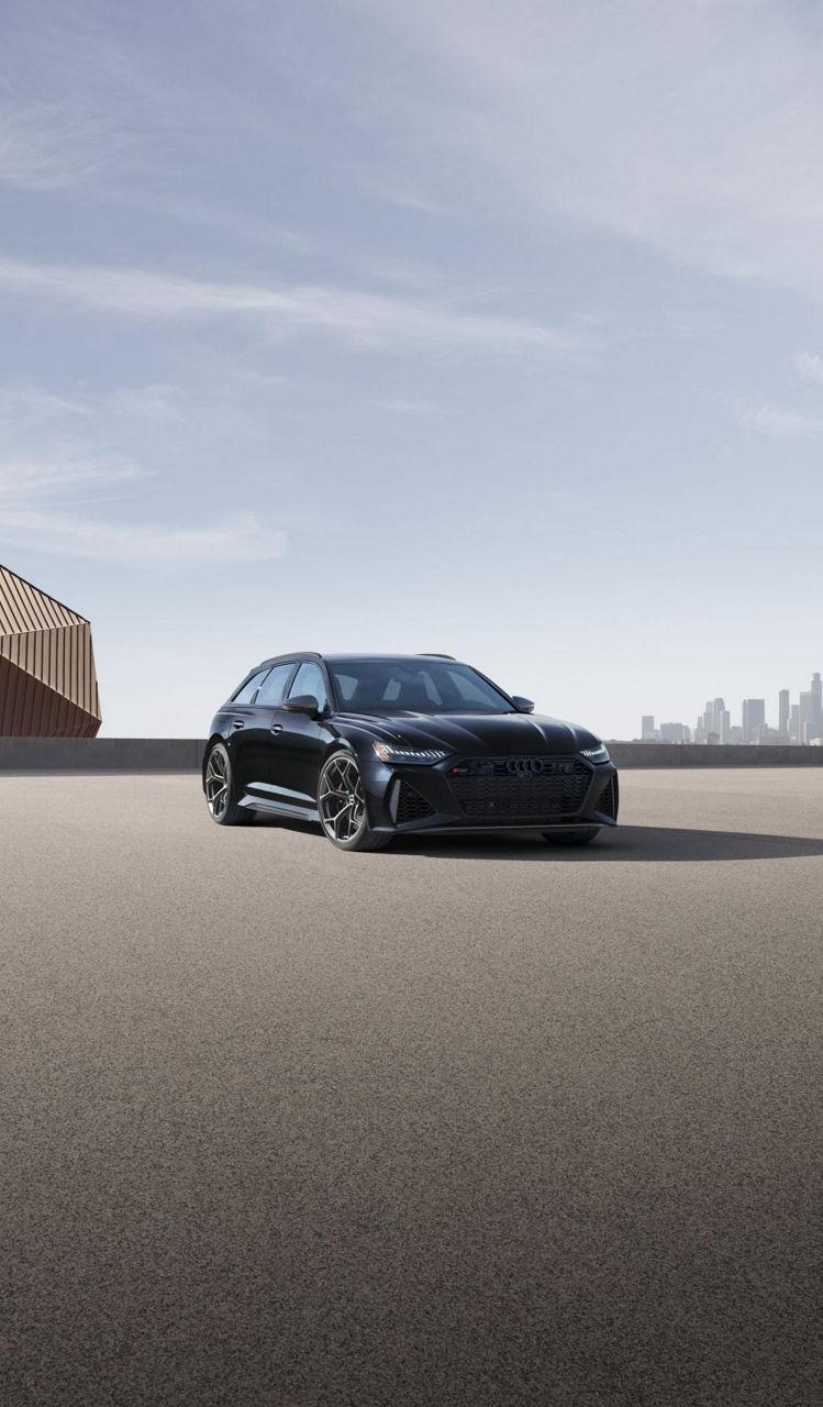 Left side profile view of an Audi Q6 parked.