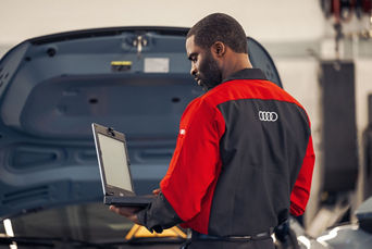 Service technician inspecting a vehicle