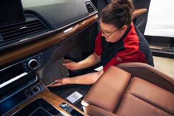 Audi Service Advisor changing a cabin filter.