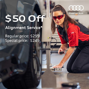 Audi technician performing an alignment service