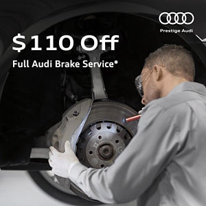 Audi technician inspecting brakes