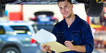 Service technician servicing tire.