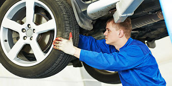 Service technician serving vehicle.