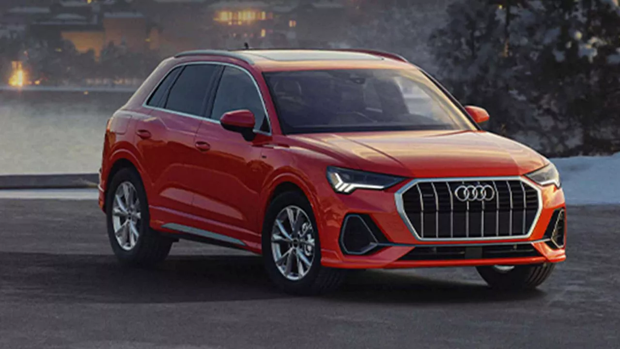 Side view of an Audi Q5 Hybrid driving.