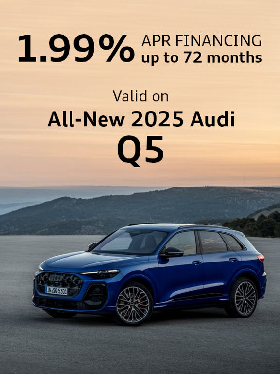 Side view of two Audis parked.