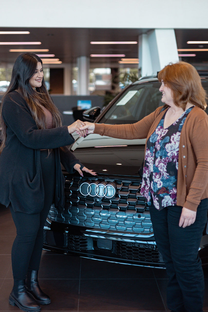 Audi Sale Specialist with a customer in the showroom.