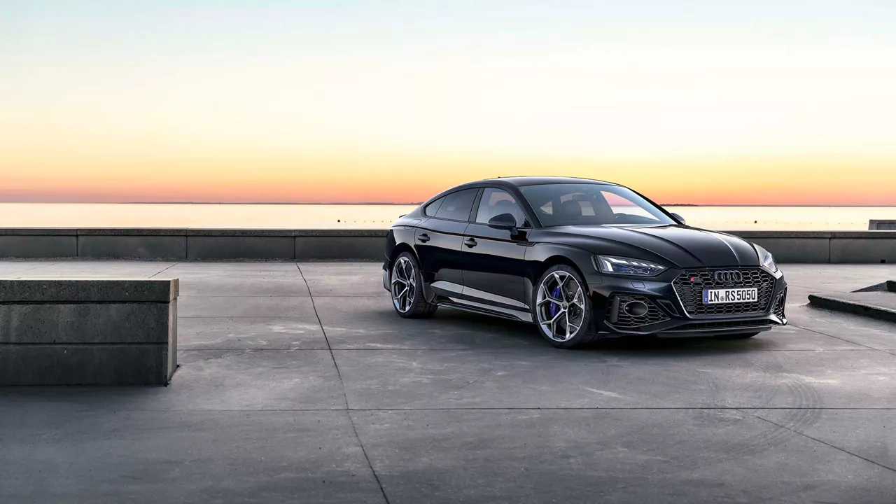 Three quarter profile view of an Audi RS 5 Sportback parked.