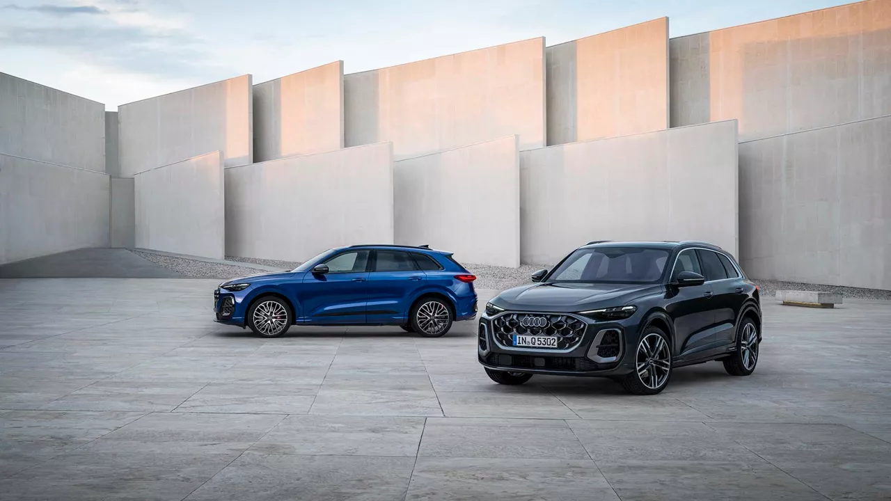 Side profile view of two audi sportsback vehicles parked.