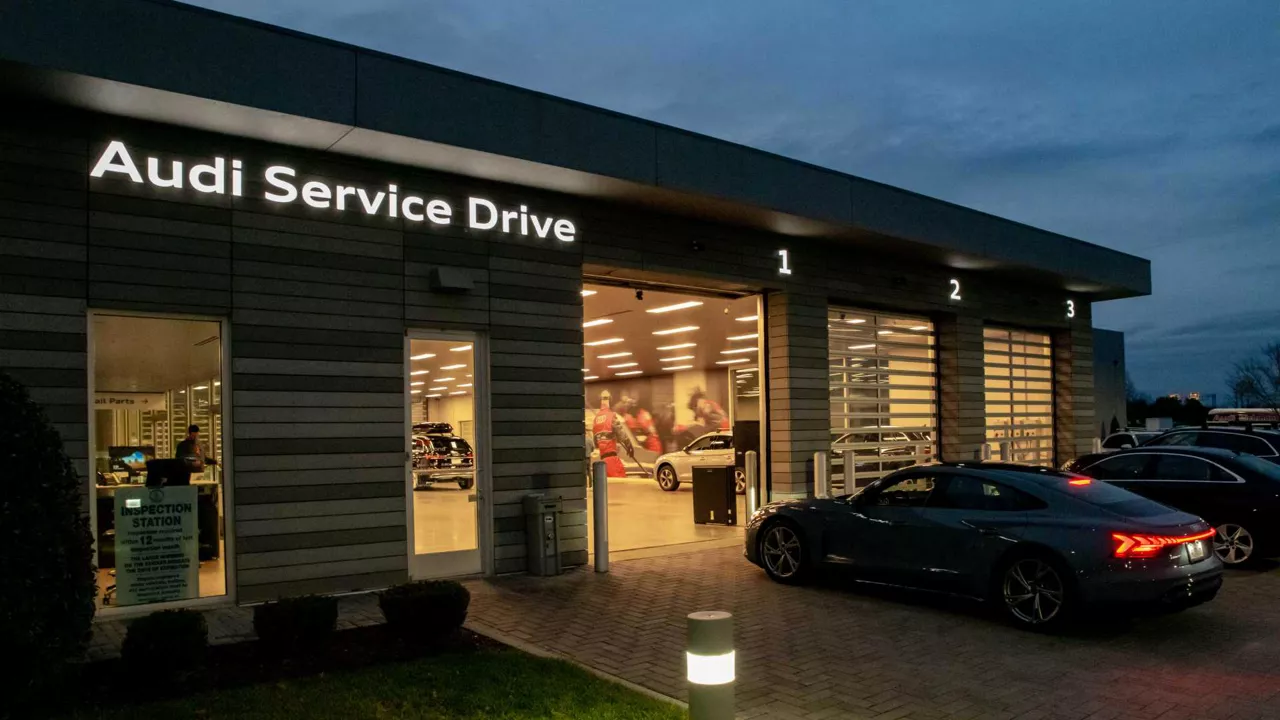 Audi service technician servicing a vehicle.