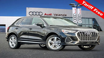 Side profile view of Audi Q3 parked.