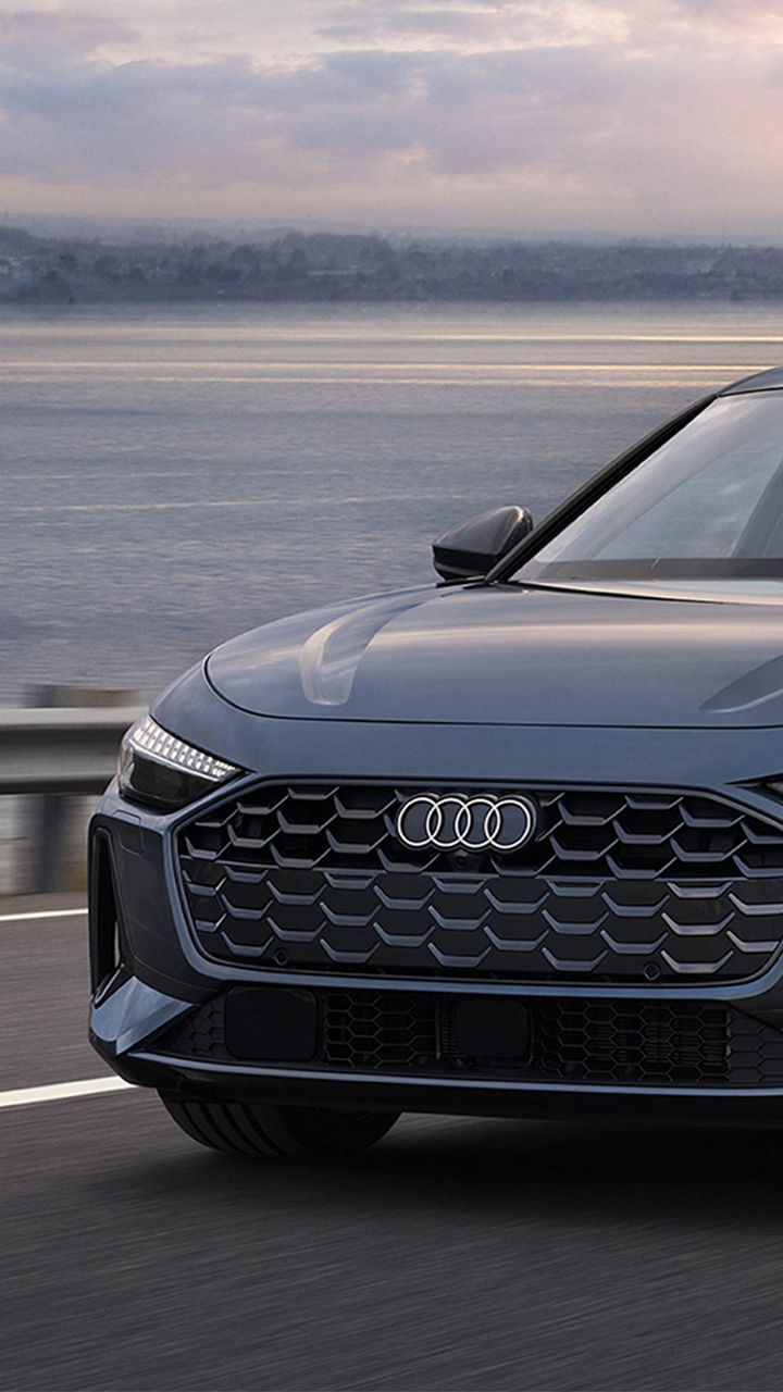 Audi 2025 Audi Q6 e-tron left profile driving.