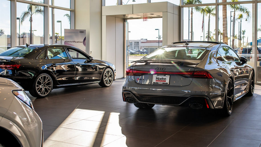 Audi Sale Specialist walking through the showroom with a couple.