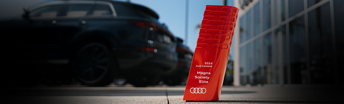 Audi Carlsbad Magna Elite Award in front of the Audi Carlsbad building